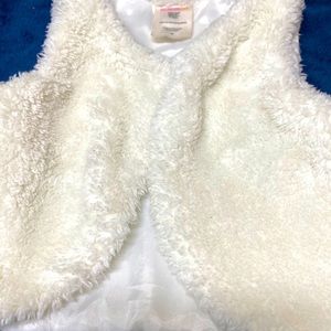 White Vest spun polyester lined with nylon.